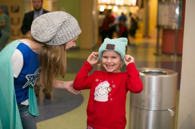 One of Love Your Melon's superheroes handing out beanies.