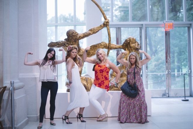 A bachelorette party posing during a Museum Hack tour.