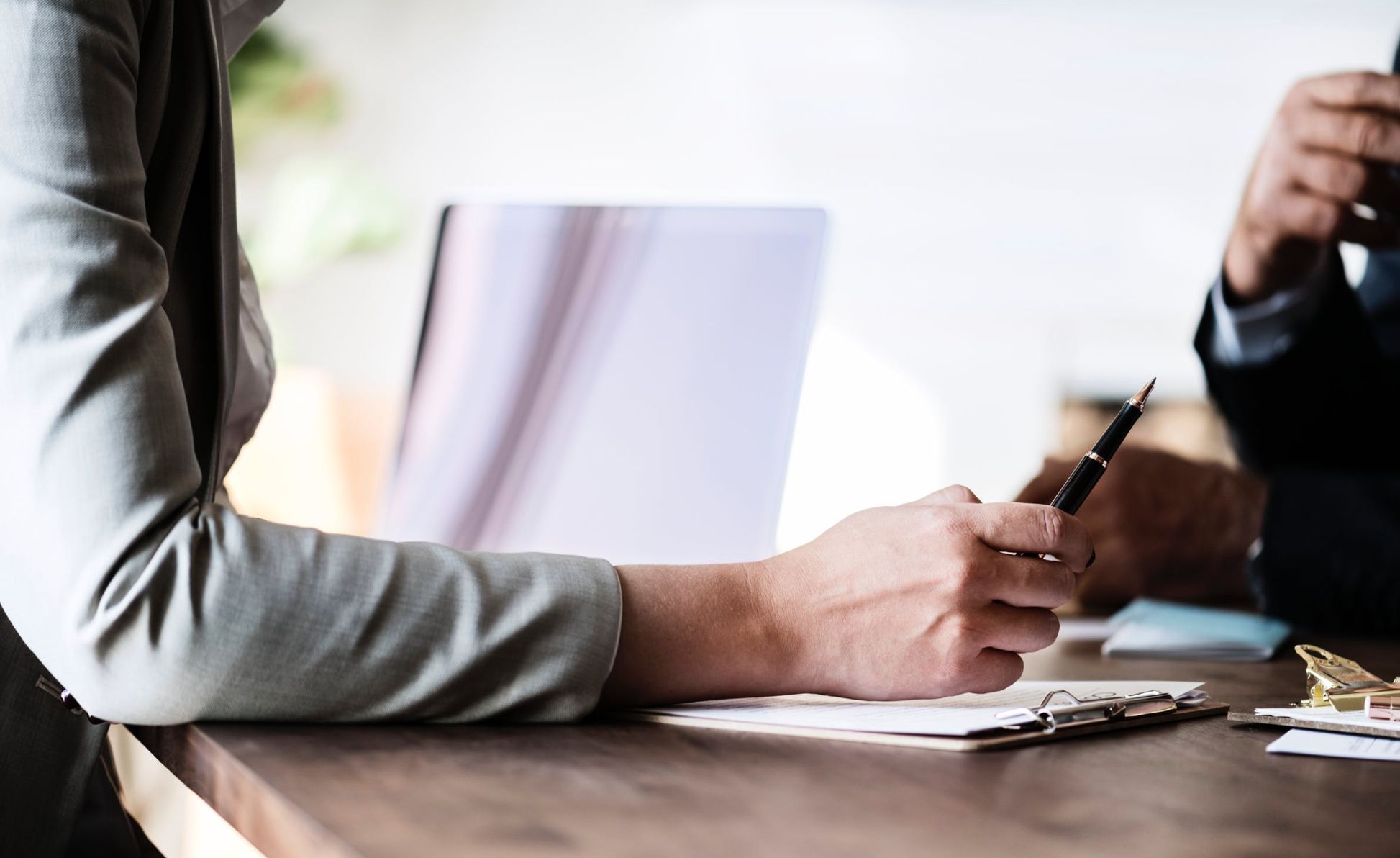 Hands of two people at a table having an interview
